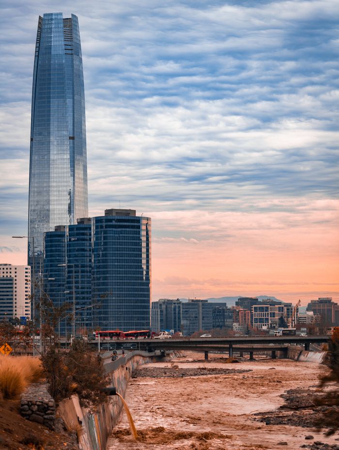 A stunning view of Santiago's skyline featuring the iconic Costanera Center at sunset.