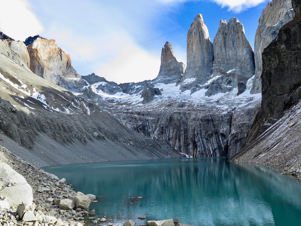 Scenic view of Torres del Paine with a turquoise lake and rugged mountains in Chilean Patagonia.